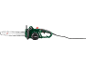 Green electric chainsaw with a black handle and a long power cable.