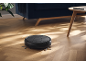 Robot vacuum cleaner on a wooden floor in a living room