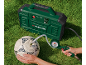 Green air compressor inflating a football on grass.