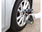 Person using a cordless impact wrench to change a car tire.
