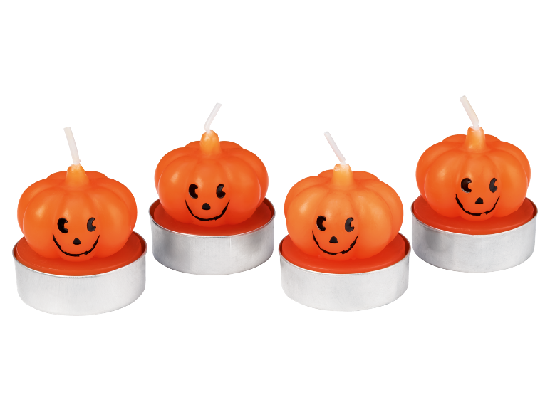 Four Halloween pumpkin-shaped tea lights with smiling faces