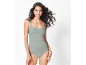 Woman in light green lace-trimmed camisole and briefs.
