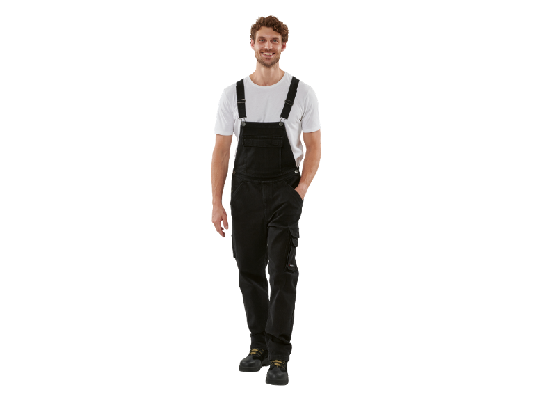 Man in black denim overalls, white t-shirt, and work boots.