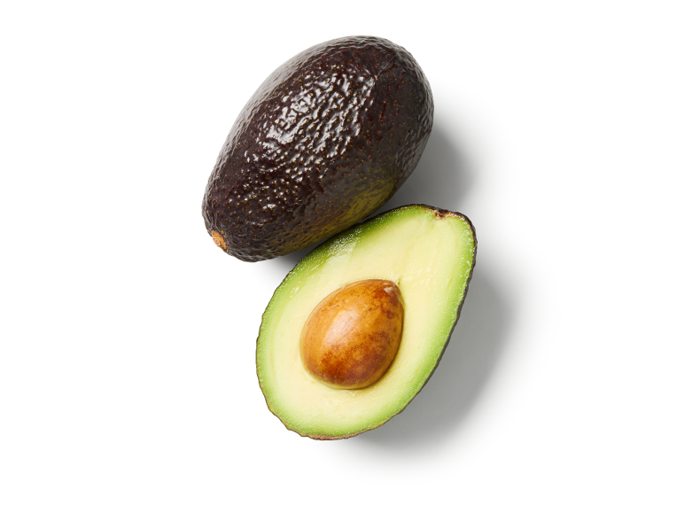 Whole and halved avocado with pit on a white background.