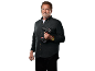 Arnold Schwarzenegger holds a cordless drill driver against a black background.