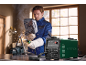 Welding machine and man welding metal with a mask and gloves.