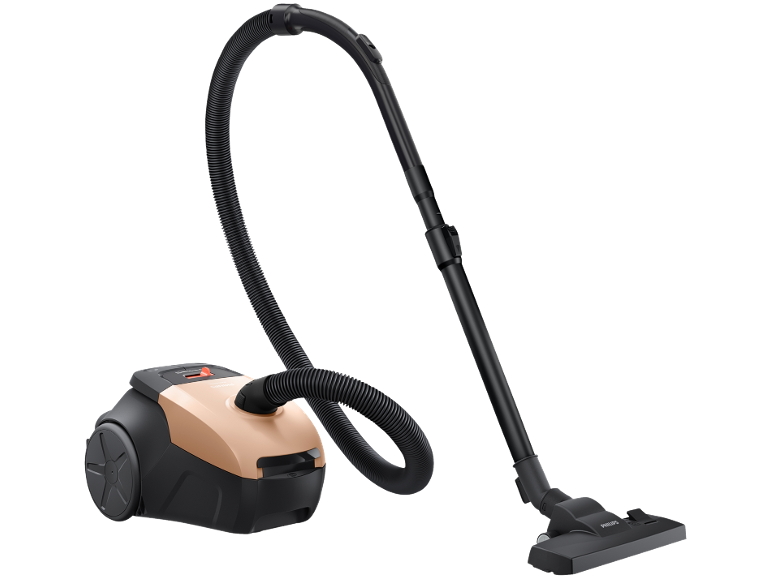 Compact copper and black canister vacuum cleaner with hose and nozzle.