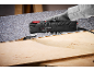 Multi-tool removing flooring from a wooden surface.
