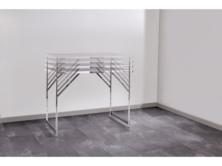 Foldable table with metal frame in an empty room with gray flooring.