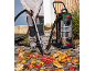 Stainless steel wet and dry vacuum cleaner used to collect autumn leaves from a paved path.