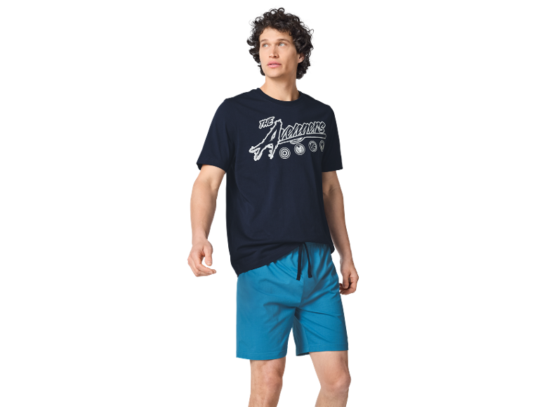 Man in a dark blue t-shirt with 'The Avengers' text and blue shorts.