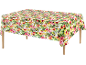 Tablecloth with tropical floral print on a wooden table.