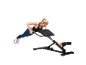 Woman doing push-ups on a multi-functional exercise bench.