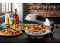 Electric pizza oven with freshly made pizzas and drinks in a kitchen setting.