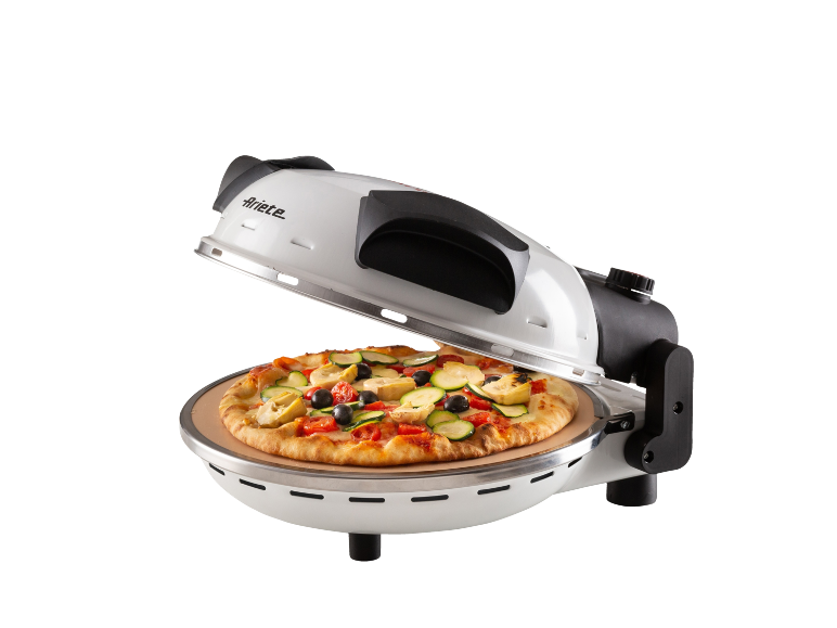 White electric pizza oven with a vegetable pizza inside.