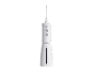 White dental irrigator with nozzle, control buttons, and water level indicator.