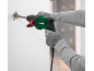Man using a rotary hammer to chisel a wall.