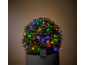 Glowing bush with multicolored solar lights in a dark pot