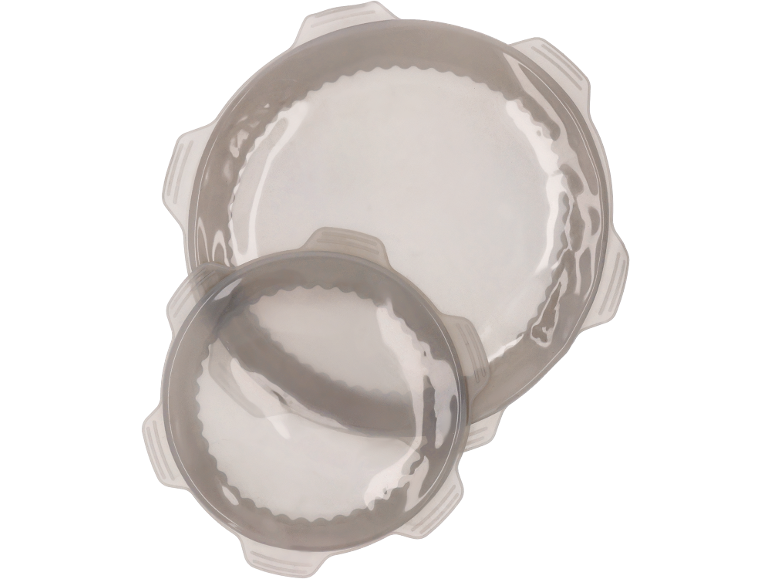 Two round silicone baking molds, one larger than the other, on a black background.