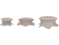 Three beige furniture risers of varying sizes, with wavy edges.