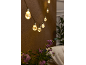 Warm string lights with purple flowers in the foreground.