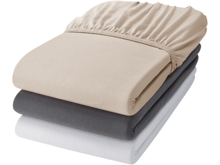 Stack of three fitted sheets in beige, grey, and white