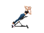 Woman performing back exercises on a training bench.