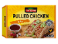 Box of pulled chicken with salsa, served with tacos and fresh ingredients.
