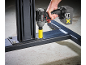 Cordless impact wrench with battery in hand, fastening a bolt to a metal structure.