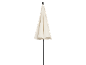 Closed cream-colored patio umbrella with a dark pole.