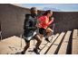 Man and woman in sportswear running up stairs.