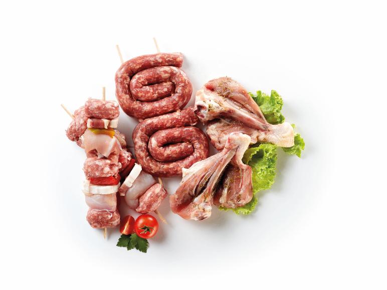 Fresh barbecue meat: skewers, sausages, and chicken drumsticks with spices and vegetables.