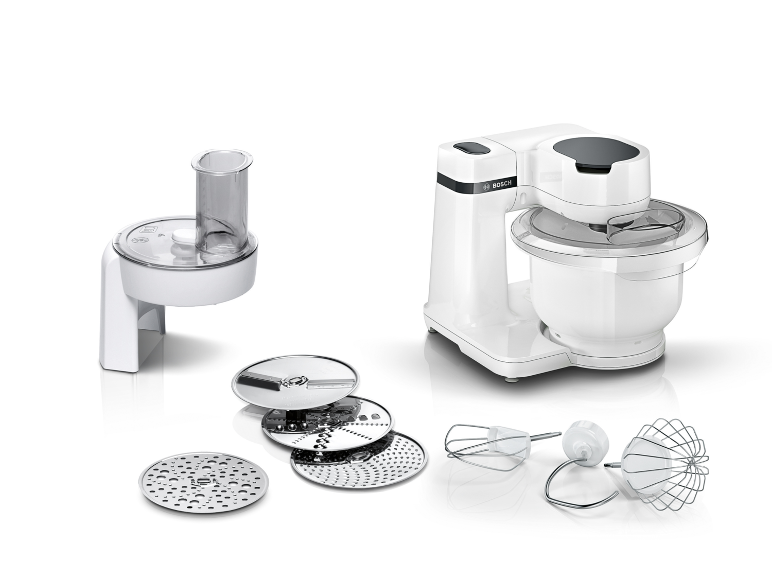 White kitchen machine with bowl, whisking and slicing attachments, and cutting discs.