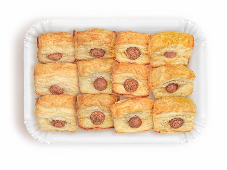Paper tray with twelve mini sausage rolls, with the sausage visible.
