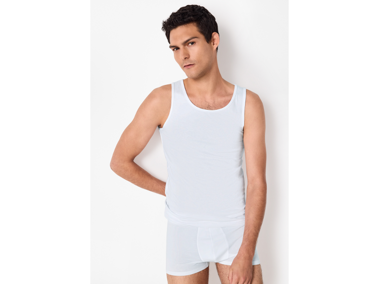 Man in white tank top and boxer briefs