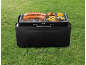 Portable grill with sausages and vegetables on grass, text «GRILL MEISTER».