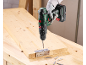 A cordless drill driver is used to attach a hinge to a wooden board.