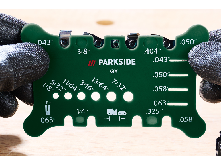 Green chainsaw sharpening guide with various measurements and gauges.