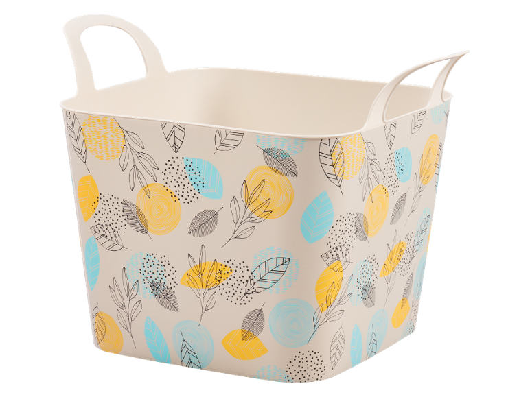 Beige flexible basket with handles and a pattern of yellow, blue leaves and dots.