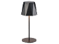 Black table lamp with a geometric shade and a round base.