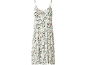 Sleeveless dress with green and brown leaf pattern on a white background.