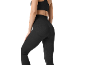 Woman in black ribbed leggings and sports top, rear view.