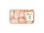Raw chicken thighs in packaging, with a label indicating a certified product.