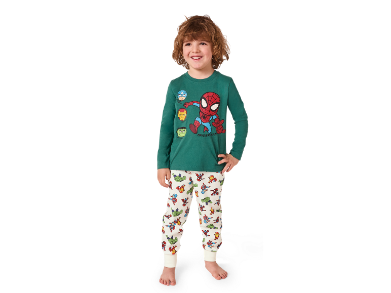Green children's pyjamas with superhero prints and white patterned trousers.