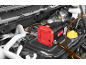 Oil pump in a car engine, with red and black housing and connected hoses.