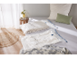 Vacuum storage bags with bedding on a bed in a bright bedroom.