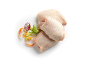 Raw chicken thighs with celery, carrots, and red onion on a white background.