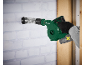 Green cordless blower with flexible nozzle, used by a person wearing gloves.