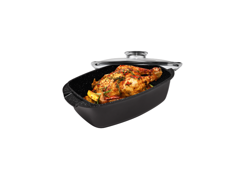 Roasted chicken in a roasting pan with a glass lid