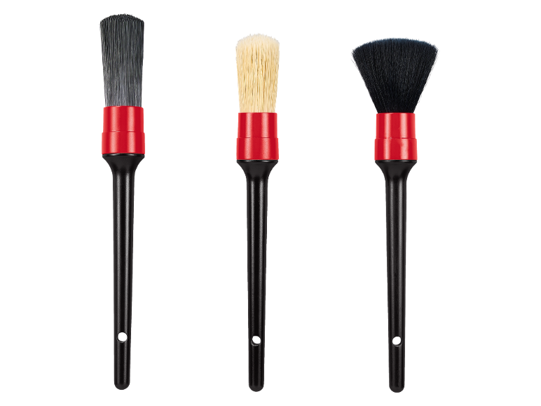 Three car detailing brushes with red ferrules and black handles.